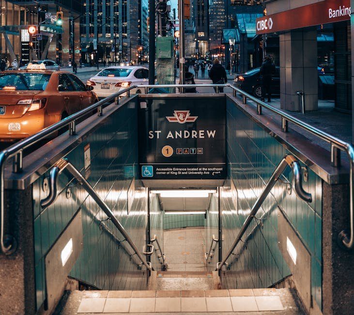 Urban scene of St. Andrew subway entrance in Toronto during evening rush hour